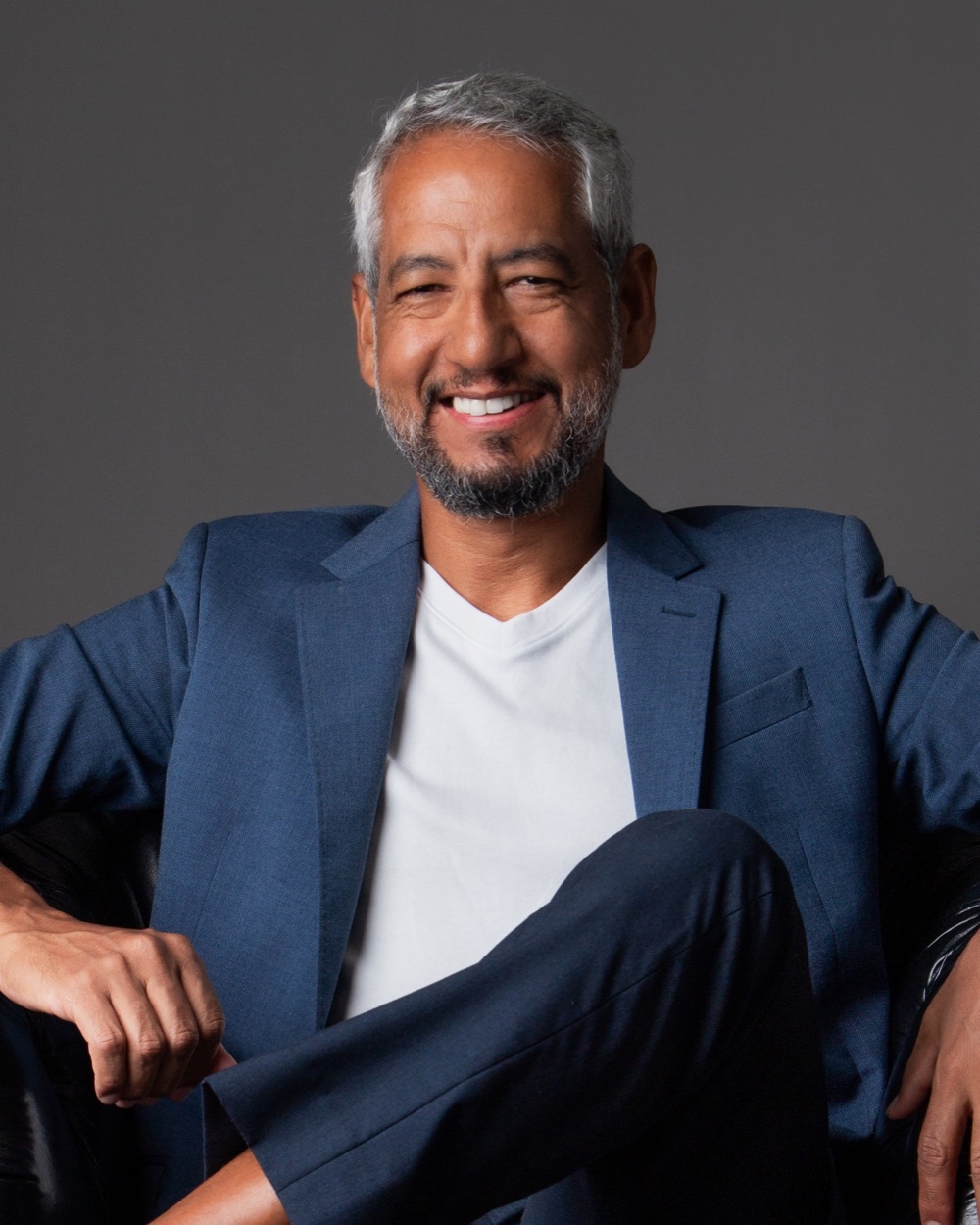 Jonas Santos, founder of C&T Biz, smiling, in a blue blazer and white T-shirt